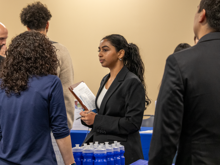 a female student speaking with an employer 